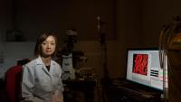 Maya Mikami, Assistant Professor of Anesthesiology, poses next to a computer displaying a medical image.